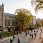 University of Michigan campus with historic buildings and autumn trees, students walking